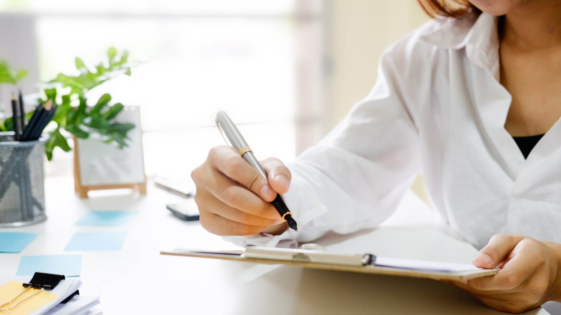 Woman writing on a Clipboard